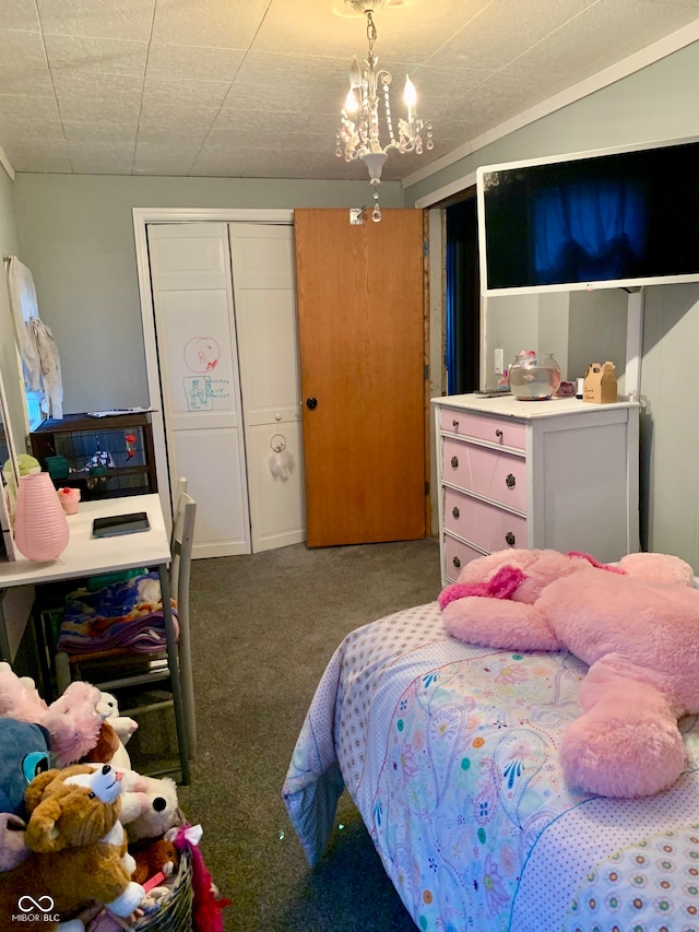 bedroom featuring a closet, carpet flooring, and a chandelier