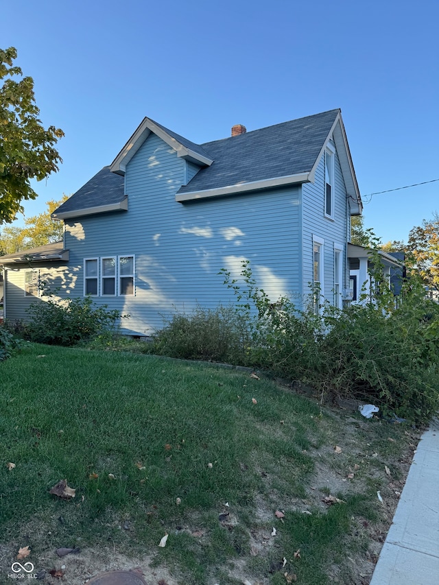 view of property exterior featuring a lawn