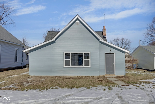 view of snow covered rear of property