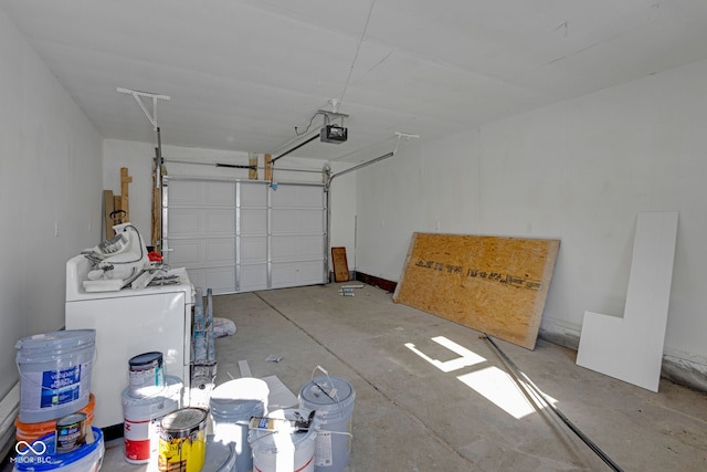 garage with washer / clothes dryer and a garage door opener