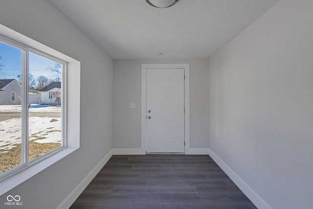 interior space featuring dark hardwood / wood-style floors and a textured ceiling