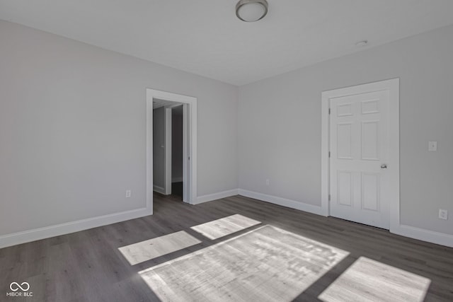 unfurnished room with dark hardwood / wood-style flooring