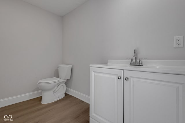 bathroom featuring hardwood / wood-style flooring, vanity, and toilet