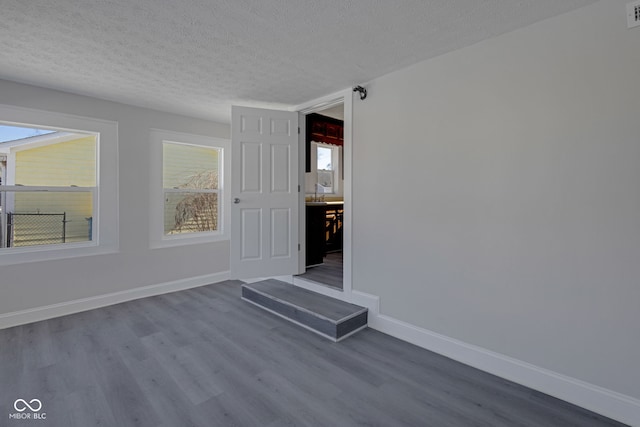 spare room with hardwood / wood-style flooring and a textured ceiling