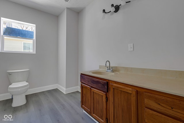 bathroom featuring vanity, toilet, and hardwood / wood-style floors