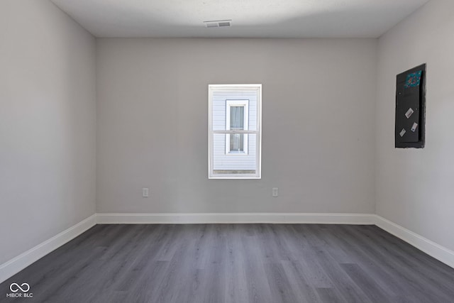 unfurnished room with dark hardwood / wood-style flooring