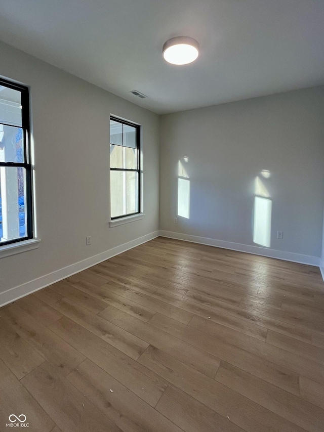 empty room with light hardwood / wood-style floors