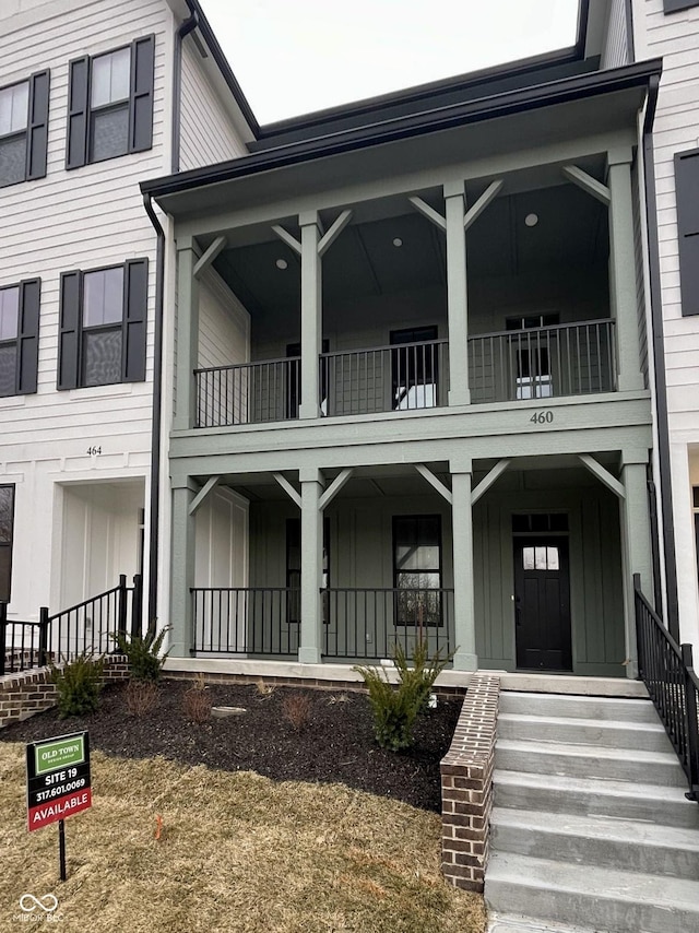 view of front of property with covered porch, board and batten siding, and a balcony