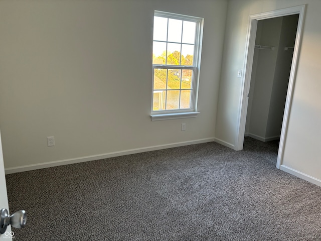 unfurnished bedroom featuring carpet floors and a closet