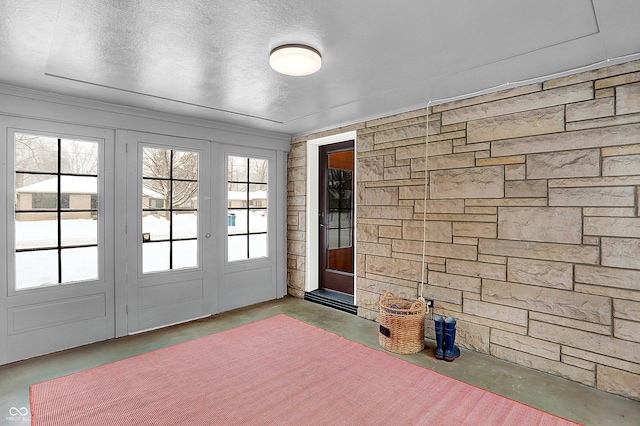 entryway with concrete floors and a textured ceiling