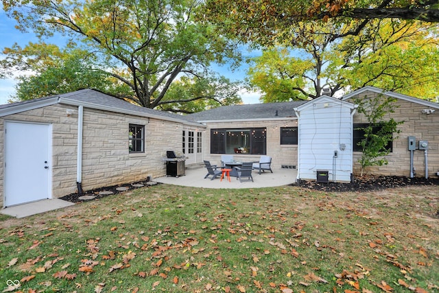 back of property featuring a lawn and a patio area