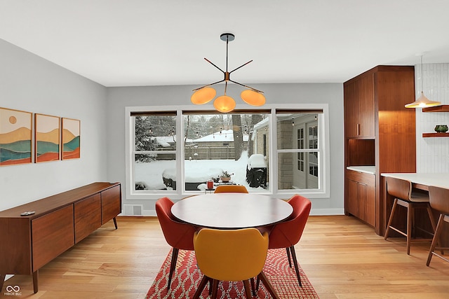 dining area with light hardwood / wood-style floors