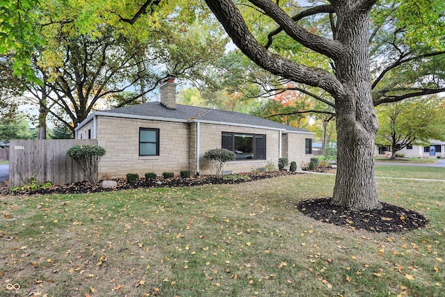 ranch-style home with a front lawn