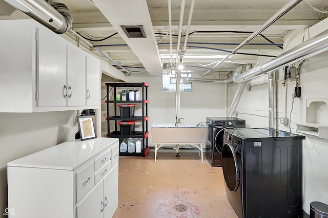 basement with sink and washing machine and clothes dryer