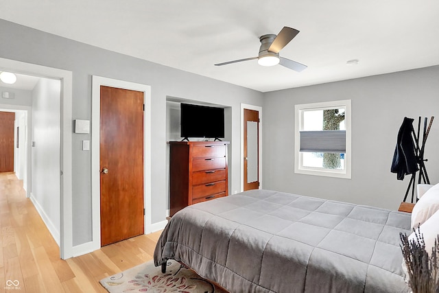 bedroom with ceiling fan and light wood-type flooring