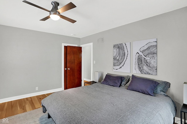 bedroom featuring hardwood / wood-style floors and ceiling fan