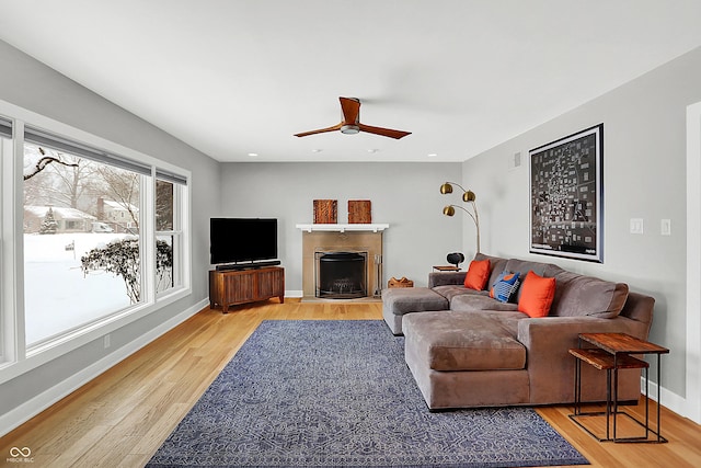 living room featuring ceiling fan and hardwood / wood-style floors