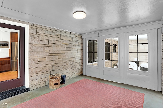 entryway with concrete flooring and a textured ceiling