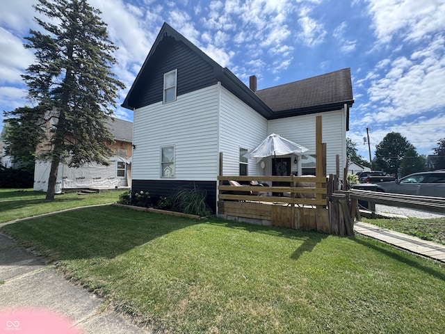 view of side of home with a yard