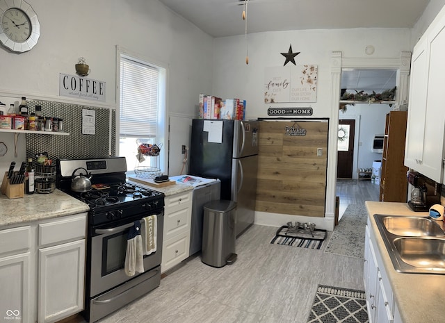 kitchen featuring white cabinetry, light hardwood / wood-style floors, stainless steel appliances, and sink