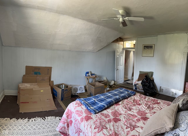 bedroom with ceiling fan, lofted ceiling, and dark hardwood / wood-style floors