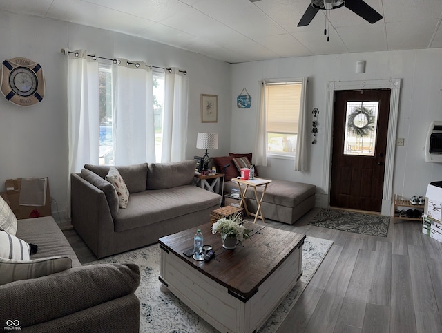 living room featuring light hardwood / wood-style flooring and ceiling fan