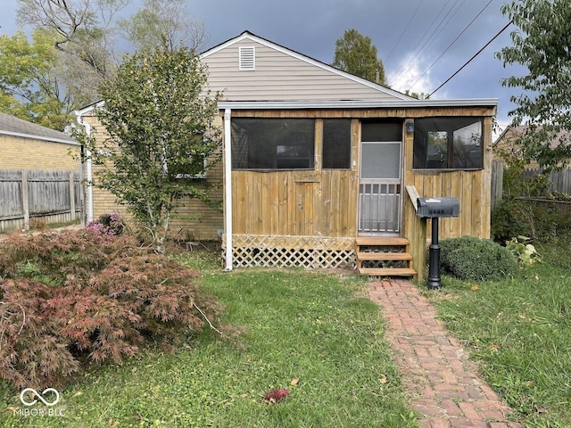 view of outbuilding featuring fence and entry steps