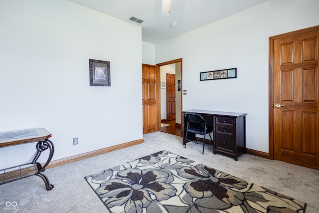 carpeted home office with ceiling fan