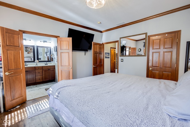 bedroom with crown molding, connected bathroom, and light wood-type flooring