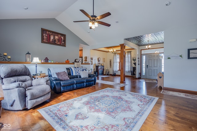 living room with ornate columns, hardwood / wood-style flooring, lofted ceiling, and ceiling fan with notable chandelier