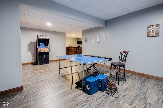 rec room featuring a paneled ceiling and wood-type flooring