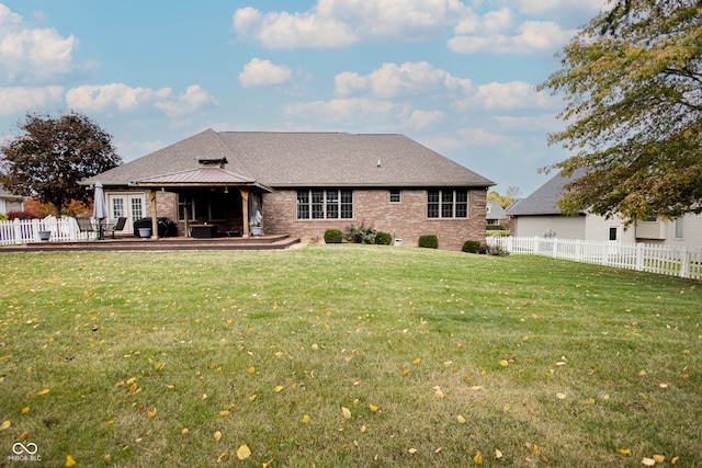 back of property featuring a patio area and a lawn