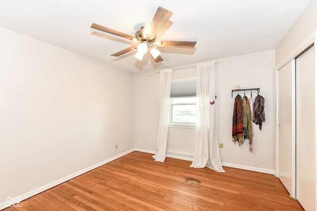 unfurnished bedroom featuring light hardwood / wood-style flooring, a closet, and ceiling fan