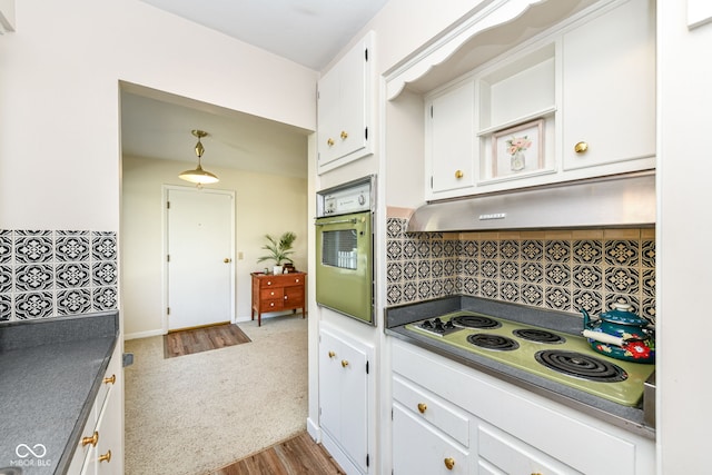 kitchen featuring oven, white cabinetry, hardwood / wood-style flooring, white electric stovetop, and decorative light fixtures