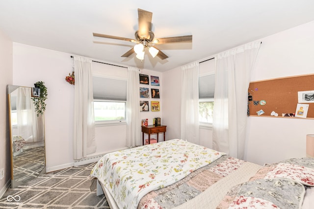 bedroom with ceiling fan and dark colored carpet