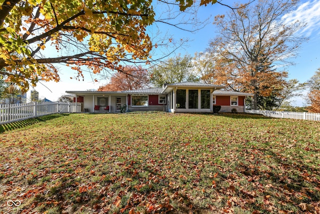 rear view of property with a lawn