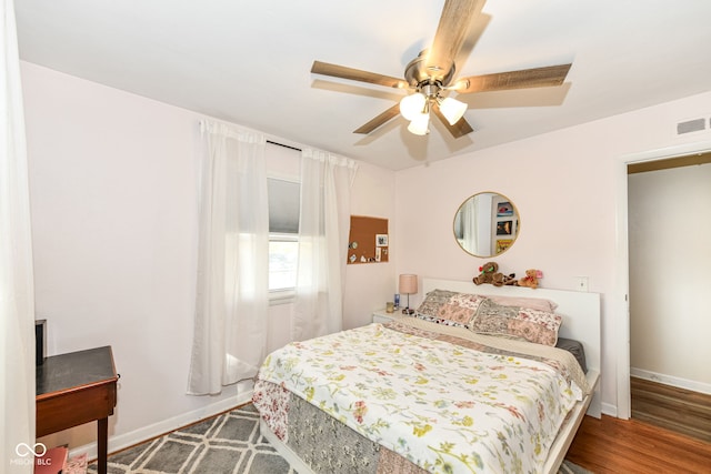 bedroom with hardwood / wood-style flooring and ceiling fan