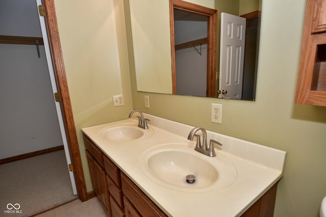 bathroom featuring tile patterned flooring and vanity