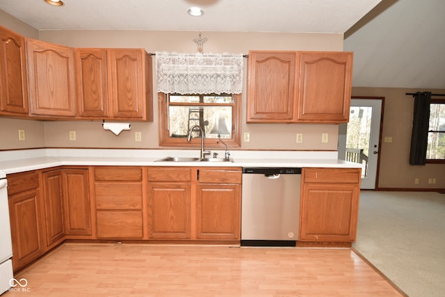 kitchen featuring dishwasher, light wood-type flooring, a healthy amount of sunlight, and sink