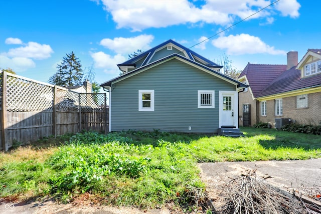 rear view of house featuring central AC