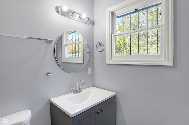 bathroom featuring toilet and vanity