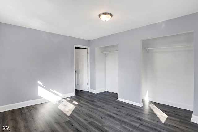 unfurnished bedroom featuring dark wood-type flooring