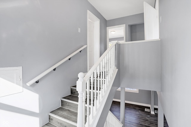 stairway featuring wood-type flooring