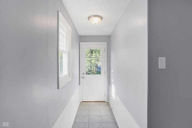 doorway to outside with light tile patterned floors