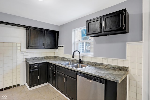 kitchen with sink, light tile patterned floors, tile walls, and dishwasher