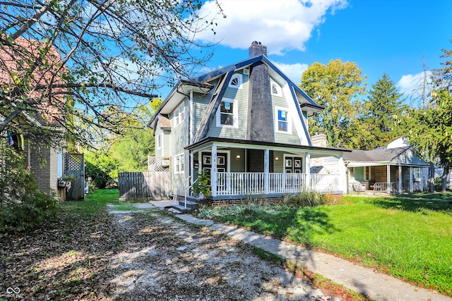 view of front facade featuring covered porch and a front lawn