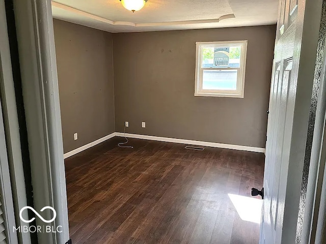 empty room featuring dark hardwood / wood-style flooring