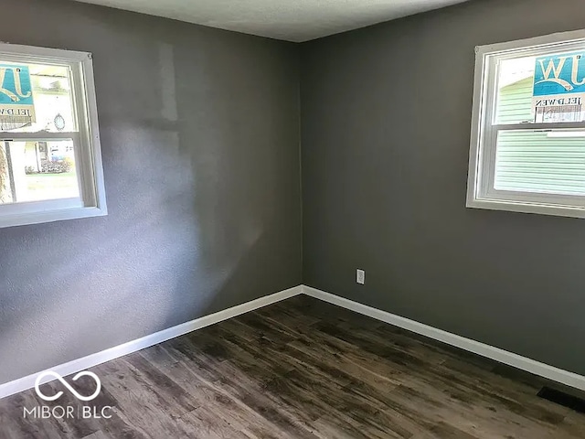 unfurnished room featuring dark hardwood / wood-style flooring