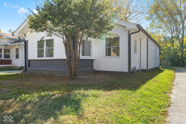 view of property exterior with a yard