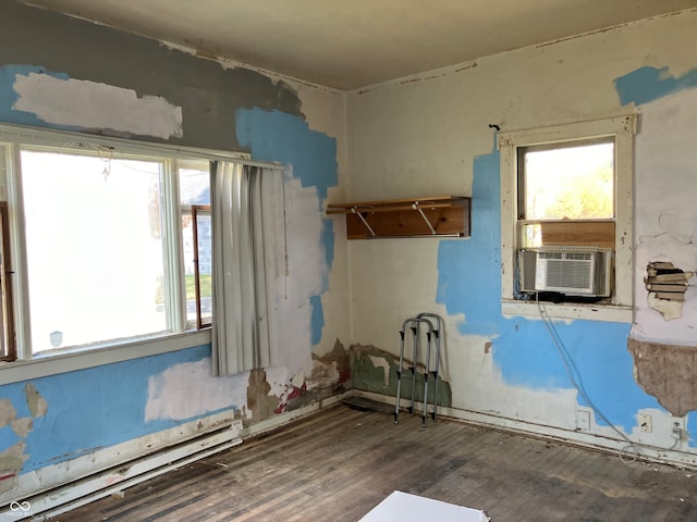 misc room featuring a baseboard radiator, cooling unit, a wealth of natural light, and dark hardwood / wood-style flooring